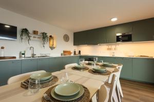 a dining room with a table and chairs and a kitchen at Quinta do Giz in Baião