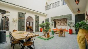 a living room with a table and chairs at Dar Alba in Marrakesh