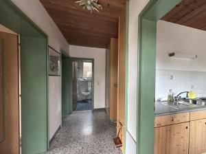 a kitchen with green and white walls and a sink at Chalet Villa Josi Superior Appartement 11 in Leutasch