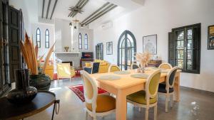 a dining room with a table and chairs at Dar Alba in Marrakesh