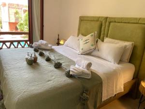 a green bed with towels and towels on it at Dar Alba in Marrakesh +60 photos