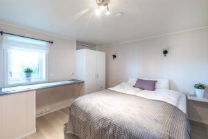 a bedroom with a large bed and a window at Modern Fjord View Apt near City in Tromsø
