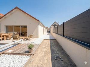 a backyard with a wooden deck and a house at Maison Nova in Talant