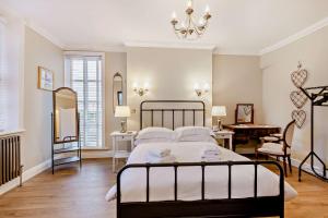 a bedroom with a large bed and a desk at Swan House in Southport