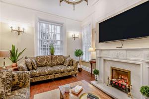 a living room with a couch and a fireplace at Swan House in Southport