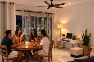 a group of people sitting around a table in a living room at Hill Venue in Coquinbourg