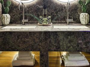 a bathroom with two sinks and two mirrors at VILLA MARRONE - Relais - in Marsala