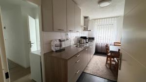 a kitchen with white cabinets and a counter top at Ferienwohnung City in Nollingen