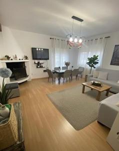 a living room with a couch and a table at Villa huetor Cerca de sierra Nevada in Huétor Vega