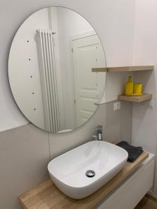 a bathroom with a white sink and a mirror at Ulivo sereno in Giulianova +7 photos