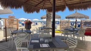 a restaurant with tables and chairs on the beach at Ulivo sereno in Giulianova
