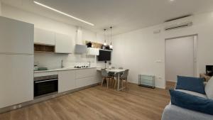 a kitchen and living room with a couch and a table at Ulivo sereno in Giulianova