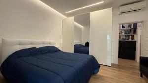 a bedroom with a blue bed and a book shelf at Ulivo sereno in Giulianova