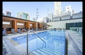 a swimming pool on the roof of a building at Condo by CN Tower & Rogers Centre in Toronto