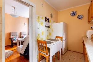 a kitchen with a white desk and a refrigerator at Apartament pod mewą in Gdynia +18 photos