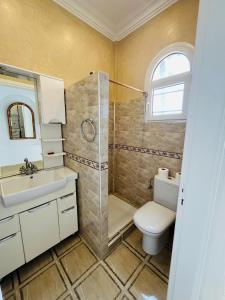 a bathroom with a shower and a toilet and a sink at DreamCatcher Homes in Mirleft +67 photos
