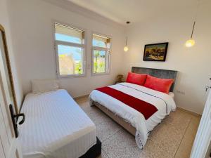 a bedroom with two beds and a window at DreamCatcher Homes in Mirleft