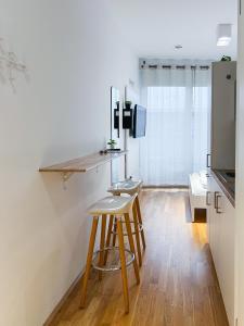 a kitchen with a counter and a stool in a room at My Room Messe Munich Apartment in Munich