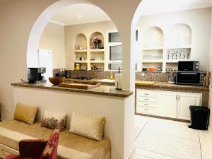 a kitchen with a counter and a couch in a room at DreamCatcher Homes in Mirleft
