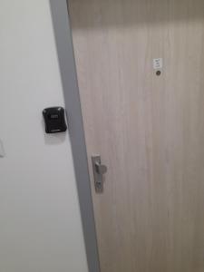 a wooden door with a black alarm on it at Apt 415 Svit in Jezersko