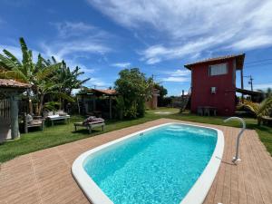 a swimming pool in front of a house at Casa Pathuá Corumbau in Corumbau