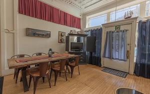 a dining room with a table and chairs and a television at Bisbee Grand Hotel, Saloon, and Music Venue in Bisbee