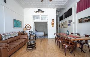 a living room with a couch and a table at Bisbee Grand Hotel, Saloon, and Music Venue in Bisbee