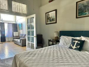 a bedroom with a bed and a living room at Bisbee Grand Hotel, Saloon, and Music Venue in Bisbee +42 photos