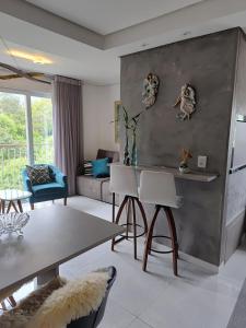 a living room with a table and chairs at Edifício Capri , apto 405 Canela RS in Canela