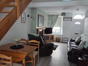 a living room with a table and a couch at Cottage in Sandwith in St Bees