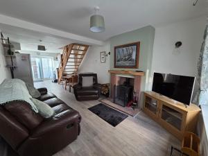 a living room with a couch and a television at Cottage in Sandwith in St Bees