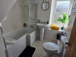 a bathroom with a toilet and a shower and a sink at Cottage in Sandwith in St Bees +20 photos