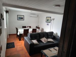 a living room with a couch and a table at Casa Dos Mosteiros in Mosteiros