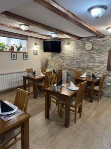 a dining room with wooden tables and chairs at B&B Millenium House 2 in Jezerce