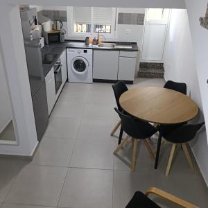 a kitchen with a wooden table and a table and chairs at Casa Lolo in Algodonales