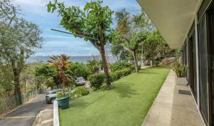 a yard with green grass and trees on the side of a house at Blue Dream Kite Boarding Resort Costa Rica in Puerto Soley