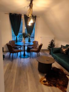 a living room with a green couch and a table at Ferienwohnung Kampić Hirsch & Heimat in Rottweil