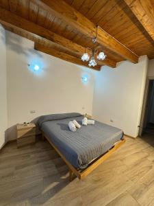 a bedroom with a bed in a room with wooden ceilings at Ginepro Home Holidays in Villanova Monteleone