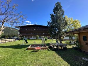 a park with a picnic table and a building at Chalet Cristall Superior Appartement 10 in Leutasch +14 photos