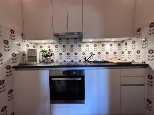 a kitchen with white cabinets and a stove top oven at Chalet Cristall Superior Appartement 10 in Leutasch