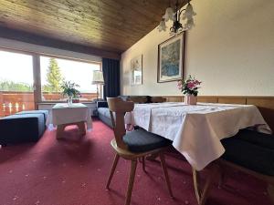 a living room with a table with flowers on it at Chalet Cristall Superior Appartement 10 in Leutasch