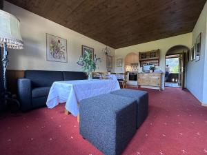 a living room with a table and a couch at Chalet Cristall Superior Appartement 10 in Leutasch