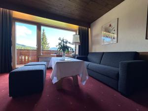 a living room with a couch and a table at Chalet Cristall Superior Appartement 10 in Leutasch