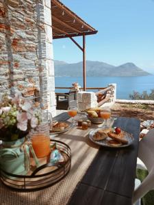 a table with food and a view of the ocean at Sofilia view house in Argilia