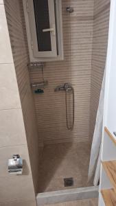 a shower with a glass door in a bathroom at ILIANA apartments in Preveza