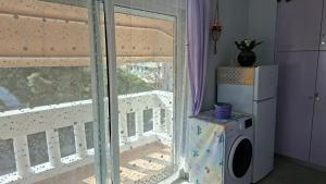 a window in a kitchen with a washing machine next to it at Mary's Apartment - Close to port, beaches in Kos +36 photos
