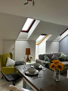 a living room with a table and a couch at Lilyscape At Whitehead in Whitehead