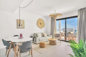 a living room with a white couch and a table at Luxury Apartment Higueron in Fuengirola