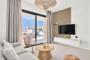 a living room with a couch and a tv at Luxury Apartment Higueron in Fuengirola