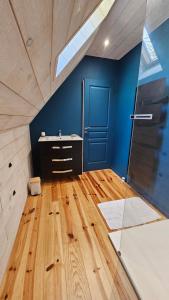a bathroom with a sink and a blue wall at Belle résidence auvergnate Vue panoramique sur la nature in Saint-Julien-de-Jordanne +45 photos